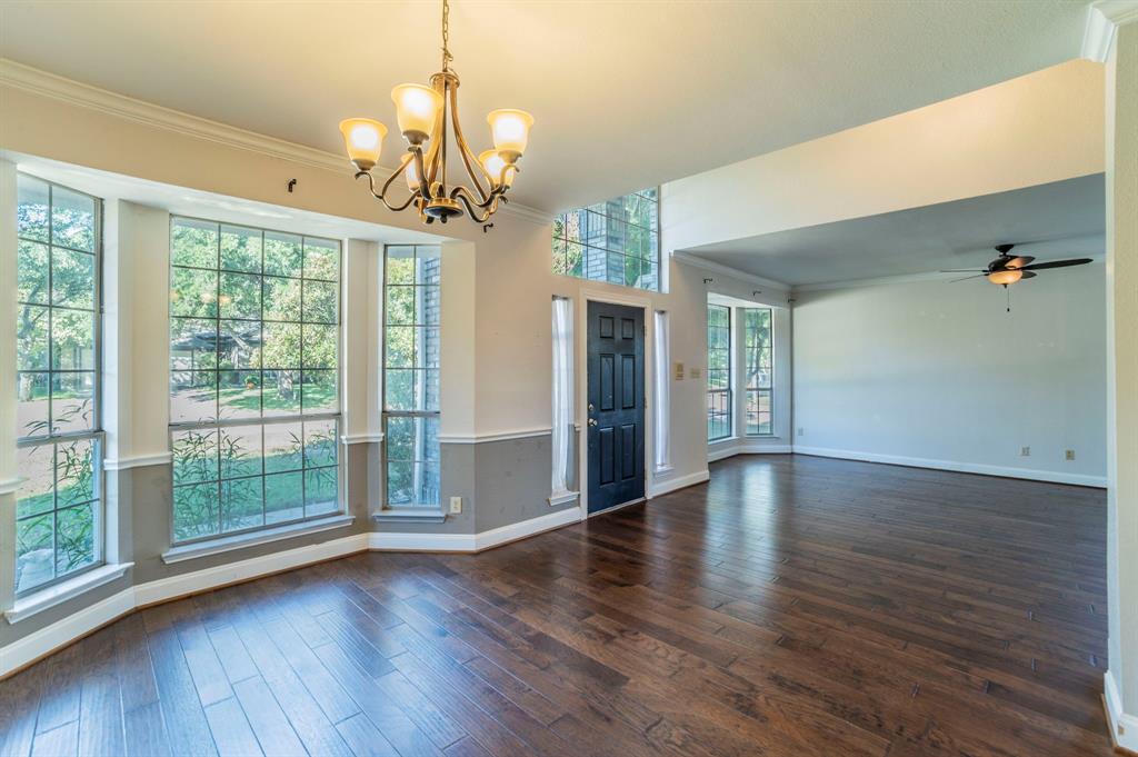 1240 Trinity Drive Benbrook, TX 76126 - Photo 32 of 33 a view of an empty room with wooden floor and a window