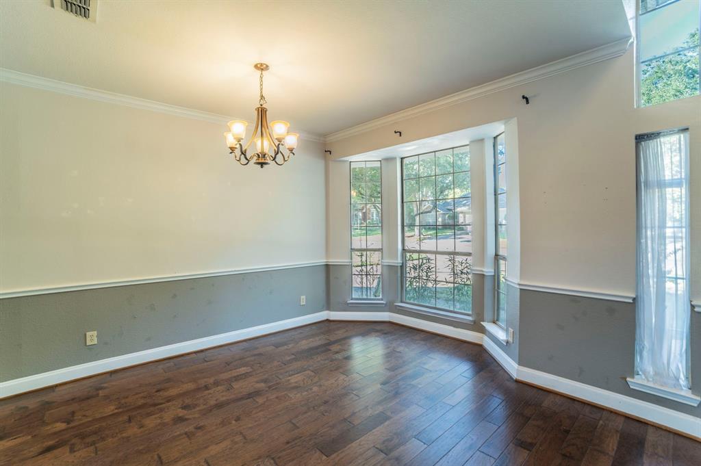 1240 Trinity Drive Benbrook, TX 76126 - Photo 8 of 33 an empty room with wooden floor and windows