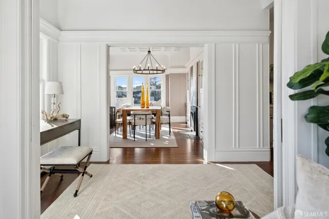 a living room with furniture and large windows