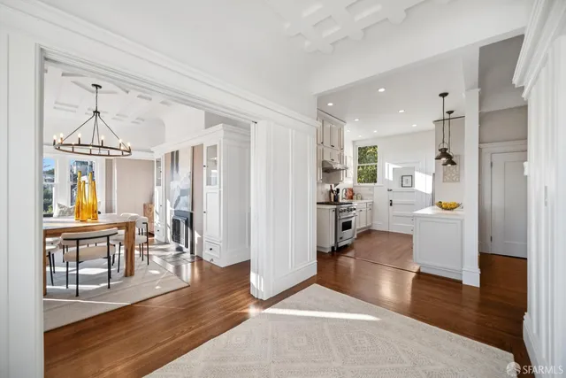 a large kitchen with stainless steel appliances granite countertop a lot of counter space and wooden floors