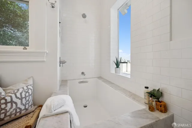 a bedroom with a bed and a potted plant