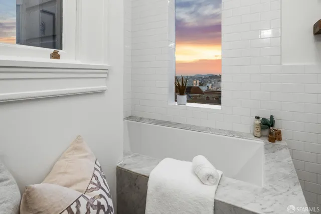 a living room with furniture a floor to ceiling window and a flat screen tv