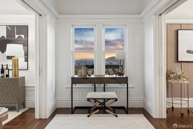a living room with furniture a fireplace and a large window