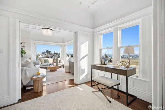 a living room with furniture potted plant and a chandelier