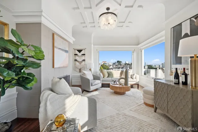 a living room with furniture and a floor to ceiling window