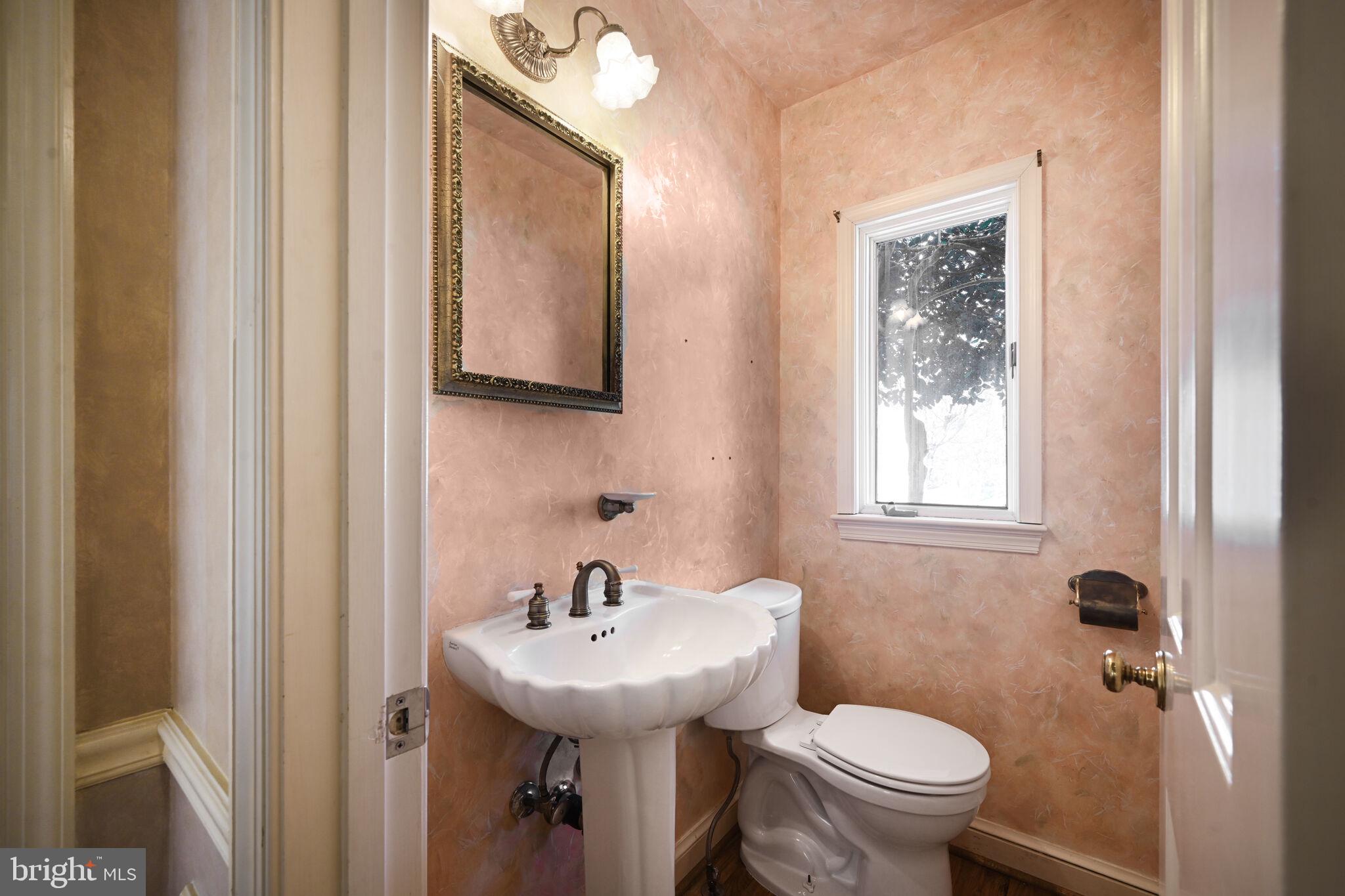 11337 Willowbrook Drive Rockville, MD 20854 - Photo 20 of 50 a bathroom with a sink a toilet and a mirror