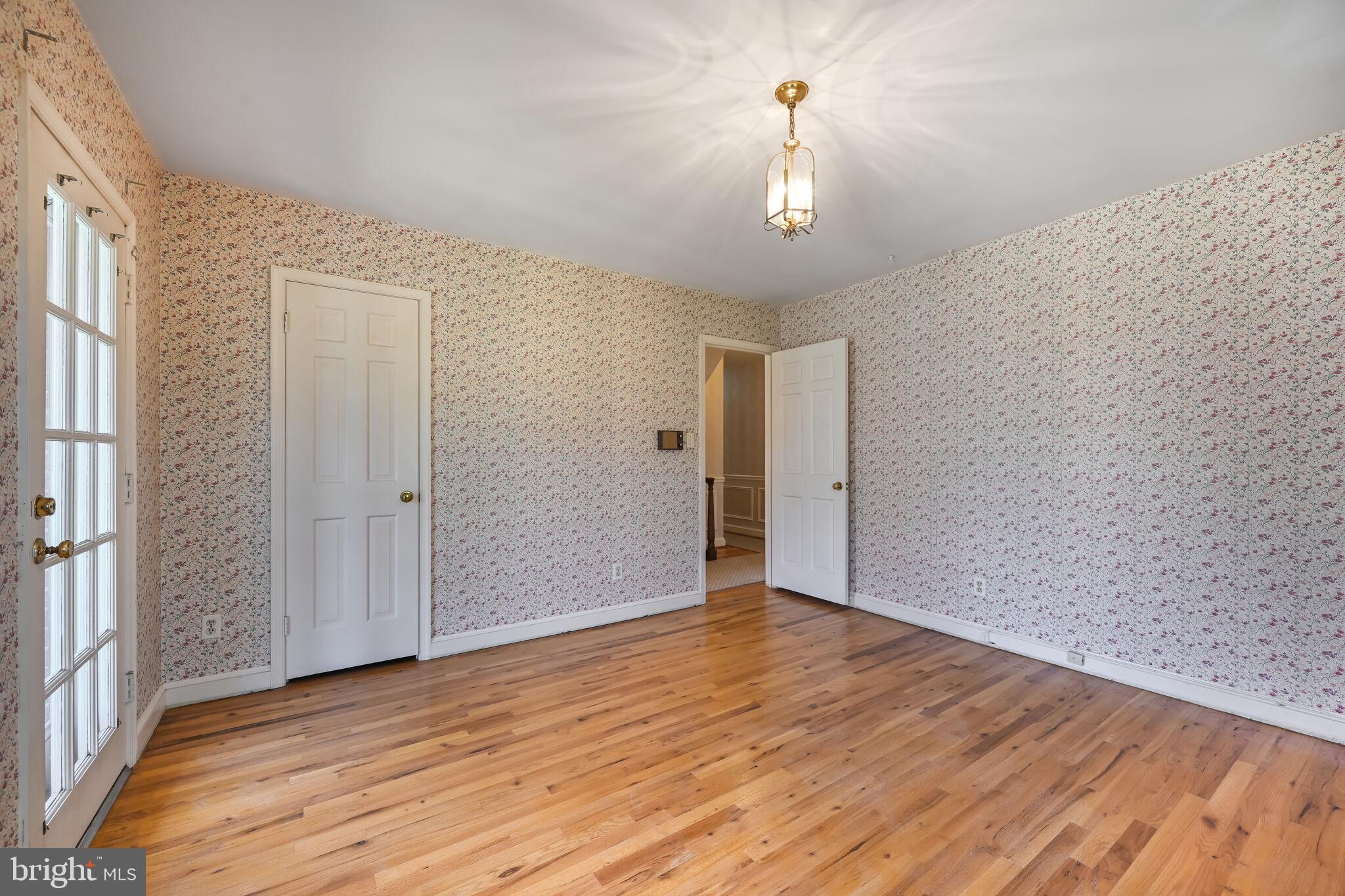11337 Willowbrook Drive Rockville, MD 20854 - Photo 24 of 50 an empty room with wooden floor and windows