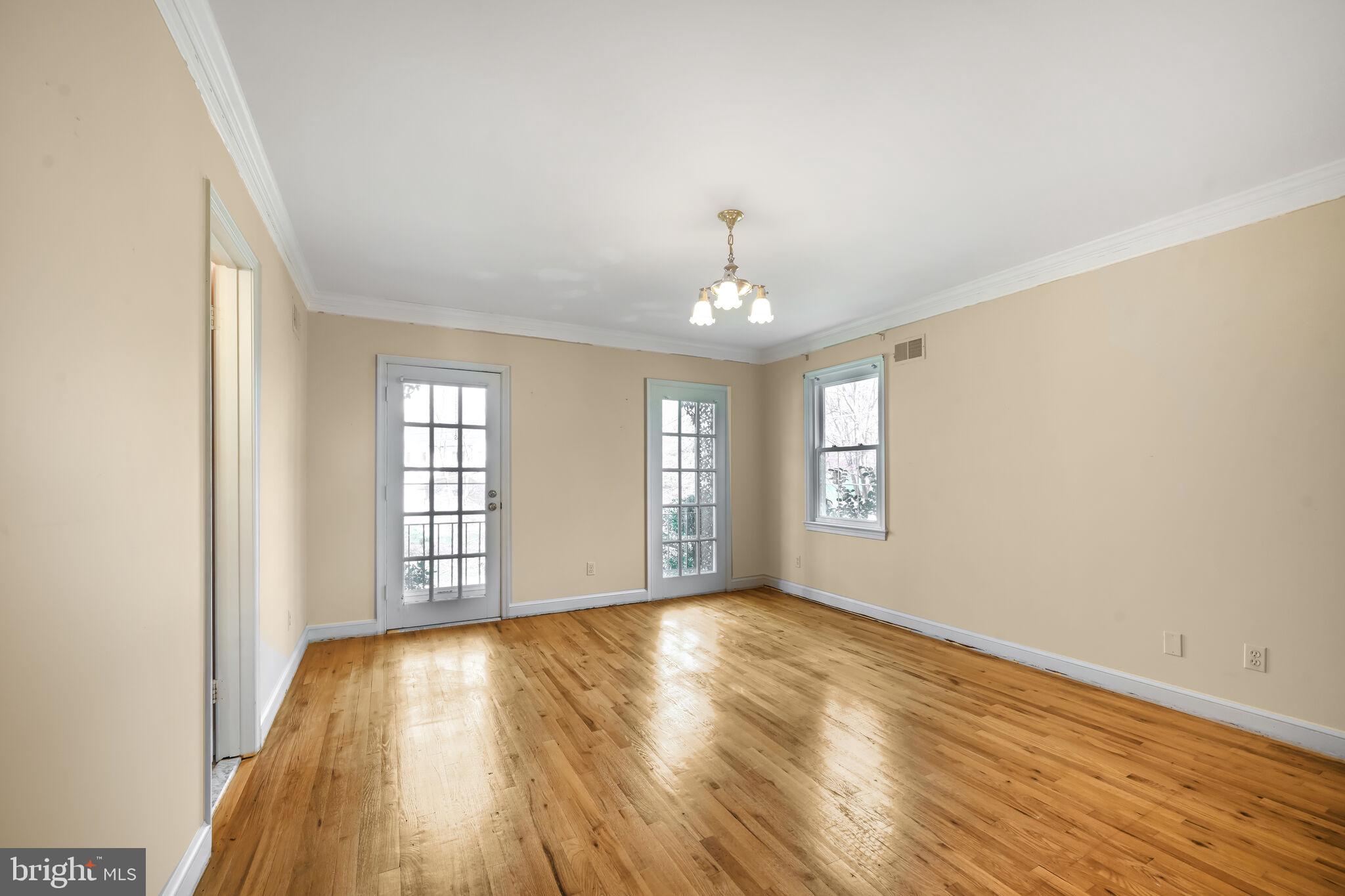 11337 Willowbrook Drive Rockville, MD 20854 - Photo 27 of 50 a view of an empty room with wooden floor and a window