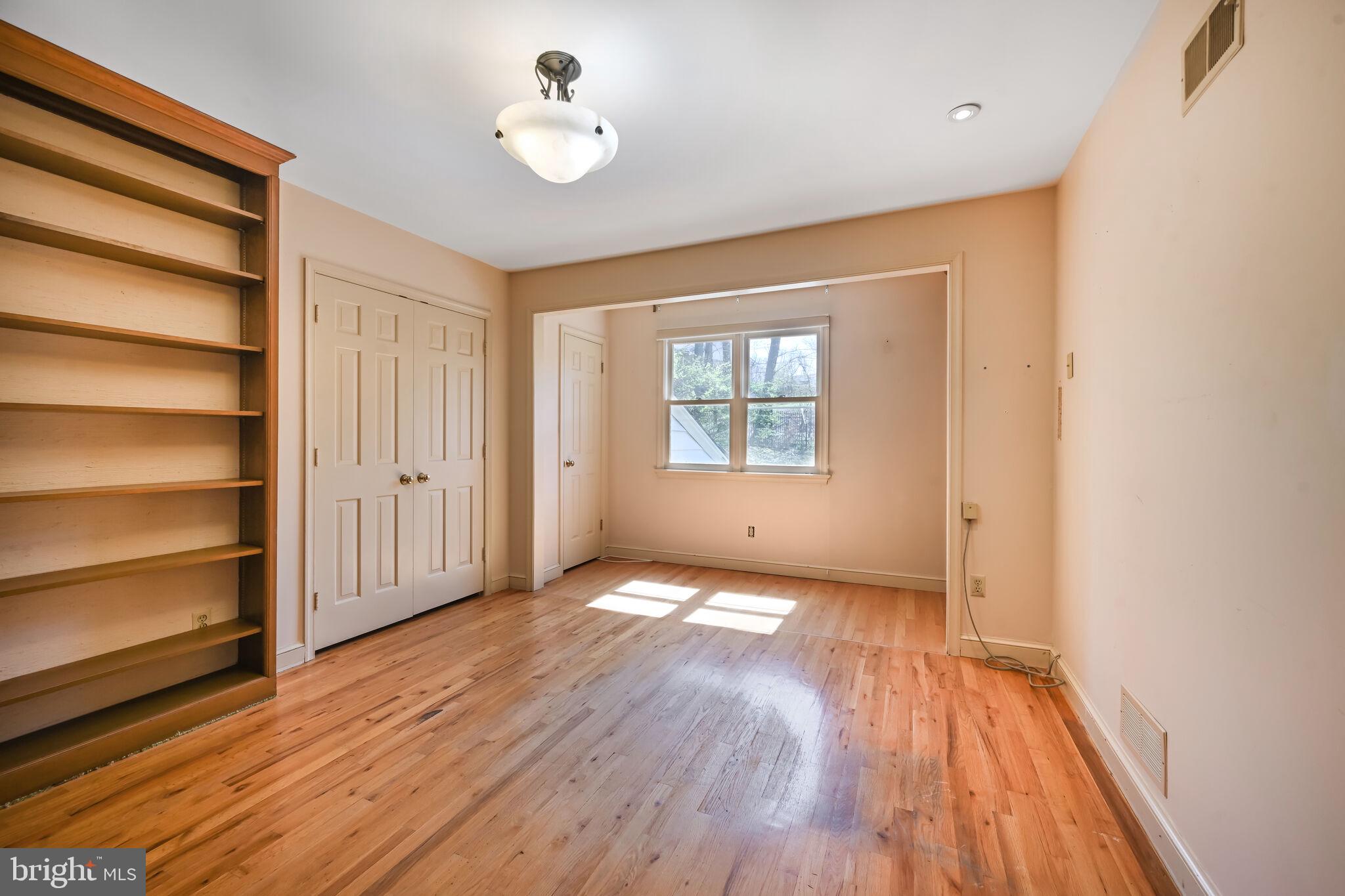11337 Willowbrook Drive Rockville, MD 20854 - Photo 31 of 50 a view of an empty room with a window and wooden floor