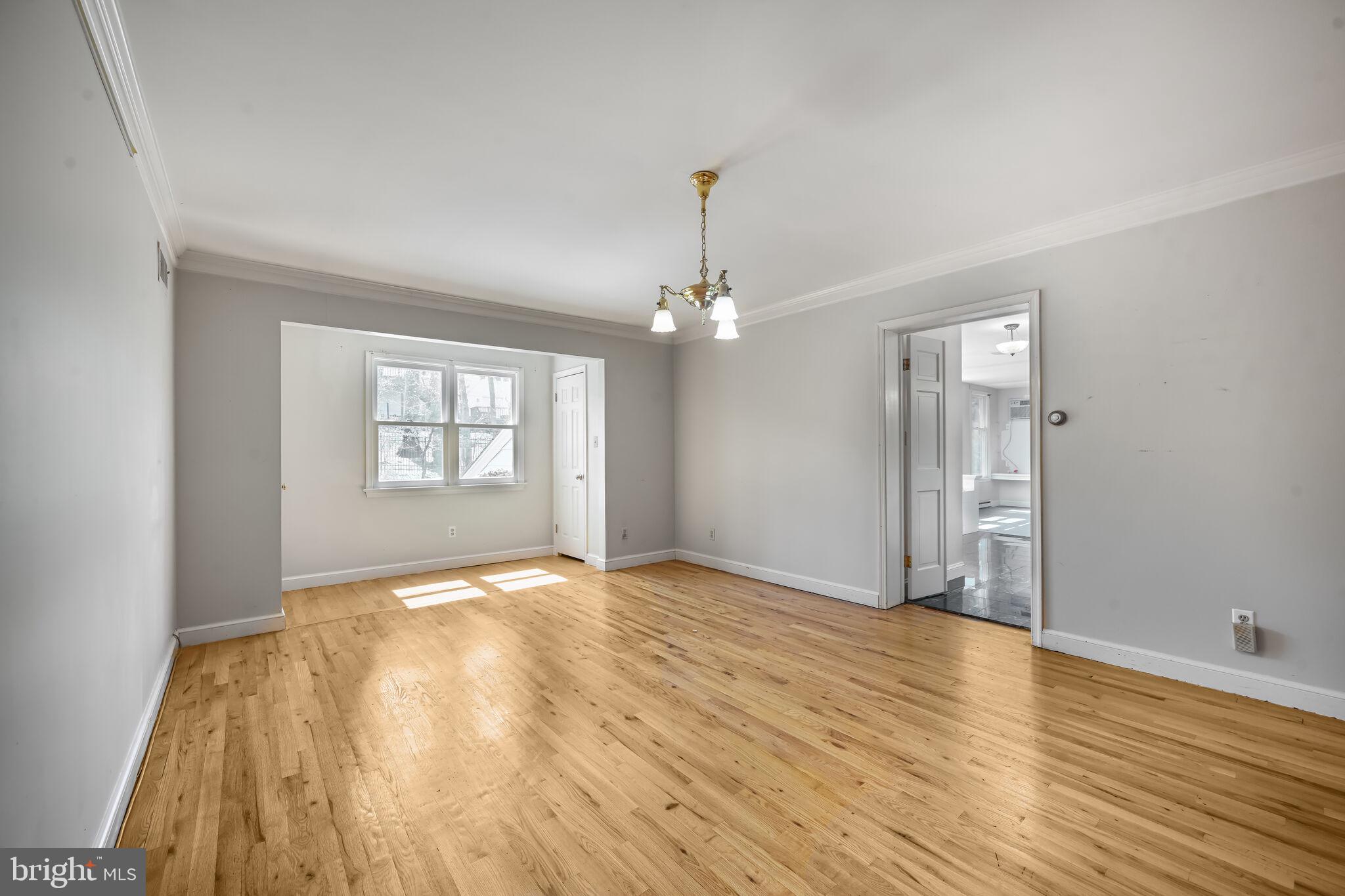 11337 Willowbrook Drive Rockville, MD 20854 - Photo 33 of 50 a view of an empty room with wooden floor and a window