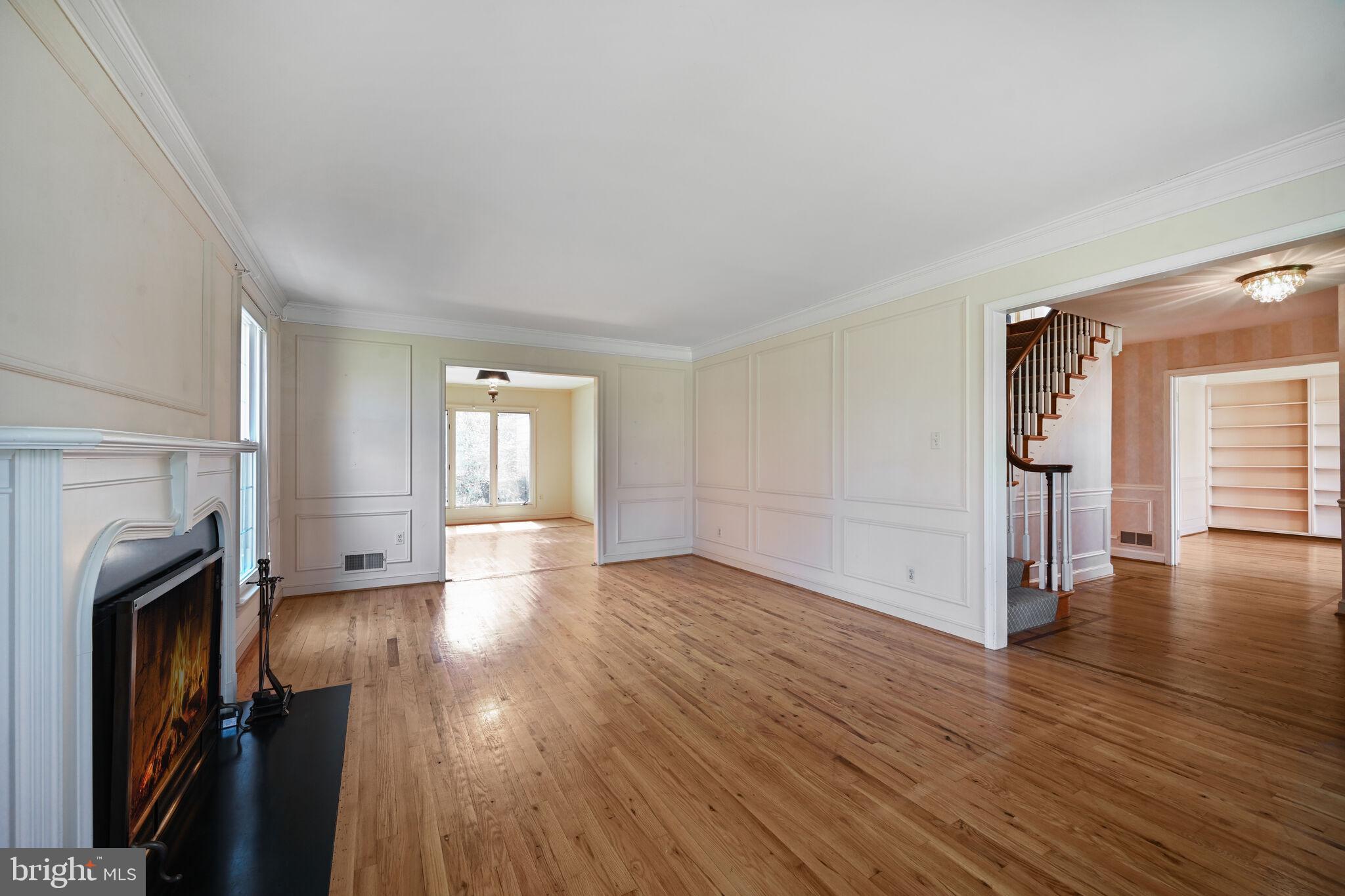 11337 Willowbrook Drive Rockville, MD 20854 - Photo 4 of 50 a view of a livingroom with wooden floor and a fireplace