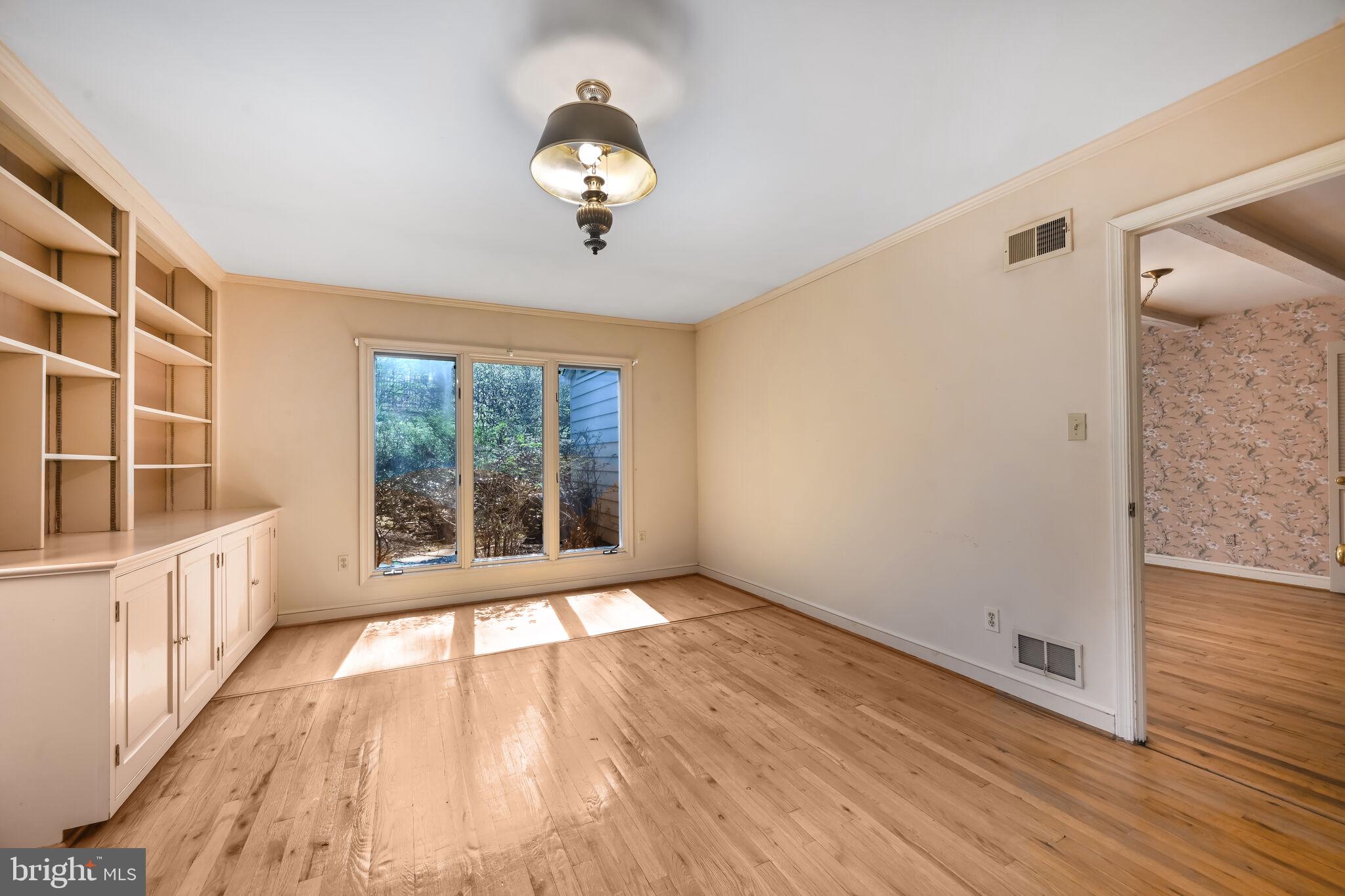 11337 Willowbrook Drive Rockville, MD 20854 - Photo 6 of 50 a view of an empty room with wooden floor and a window