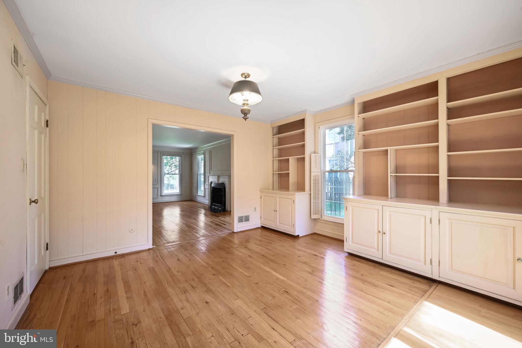 11337 Willowbrook Drive Rockville, MD 20854 - Photo 7 of 50 a view of an empty room with wooden floor and a window