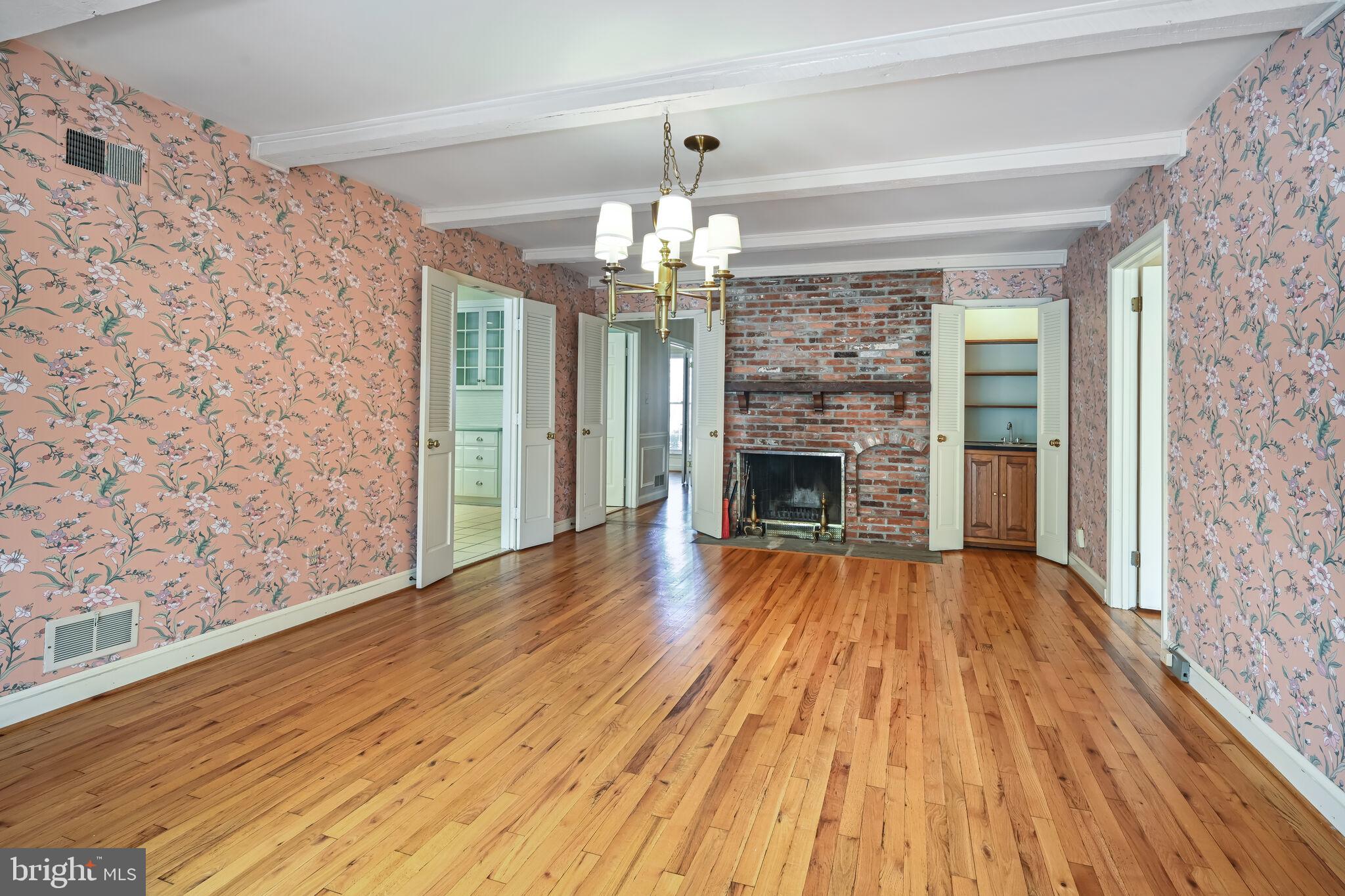 11337 Willowbrook Drive Rockville, MD 20854 - Photo 9 of 50 a view of a livingroom with wooden floor fireplace and a window