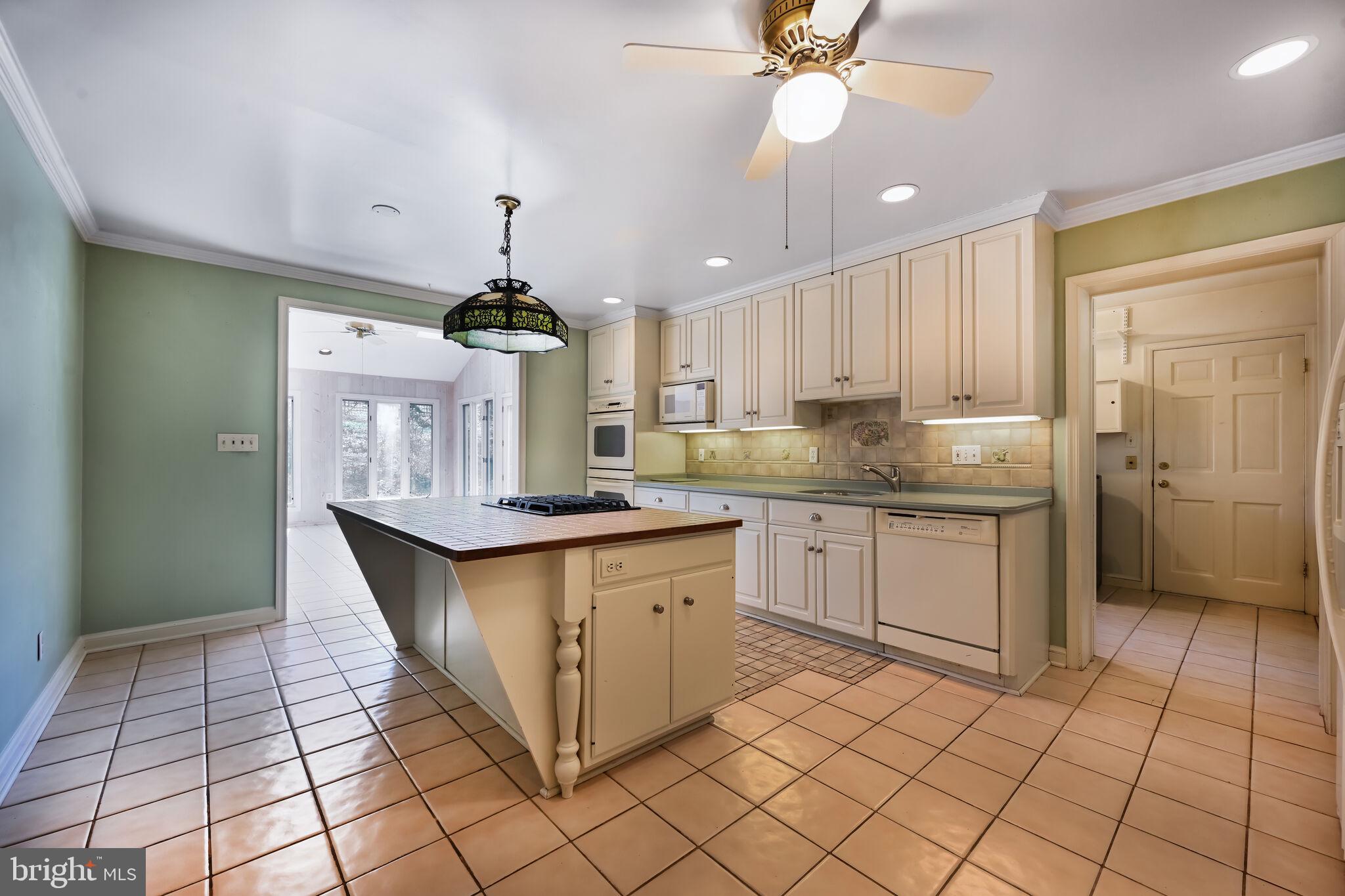11337 Willowbrook Drive Rockville, MD 20854 - Photo 10 of 50 a kitchen with kitchen island granite countertop a sink cabinets and stainless steel appliances