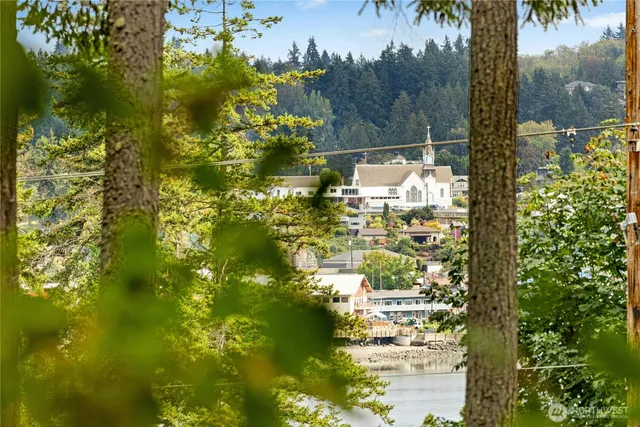 a view of a room with a large window and kitchen view
