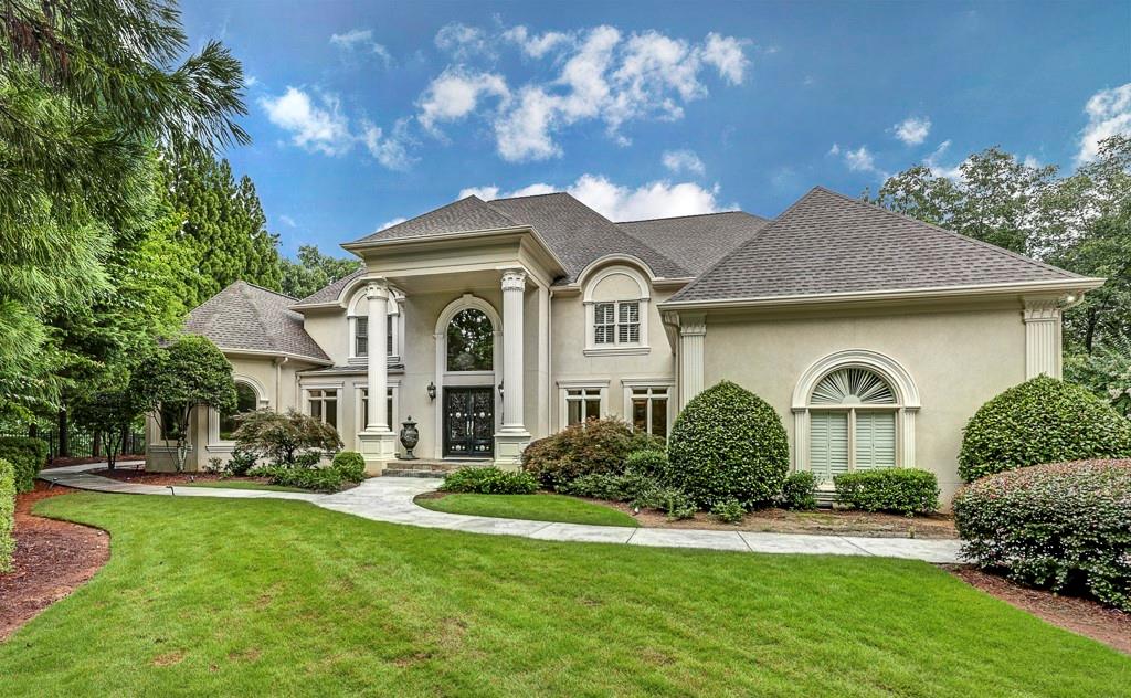 a front view of a house with a garden