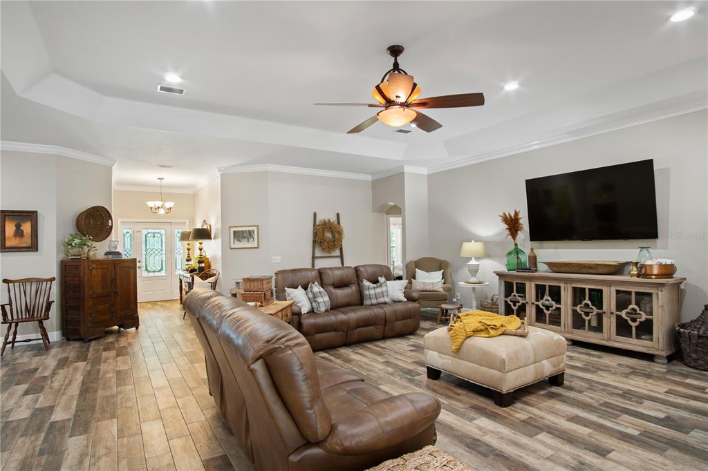 9045 Lake Hatchineha Road Kissimmee, FL 34759 - Photo 24 of 47 a living room with furniture and a flat screen tv