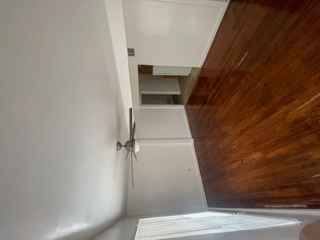 3411 Lyons Road Austin, TX 78702 - Photo 2 of 12 an empty room with wooden floor closet and windows