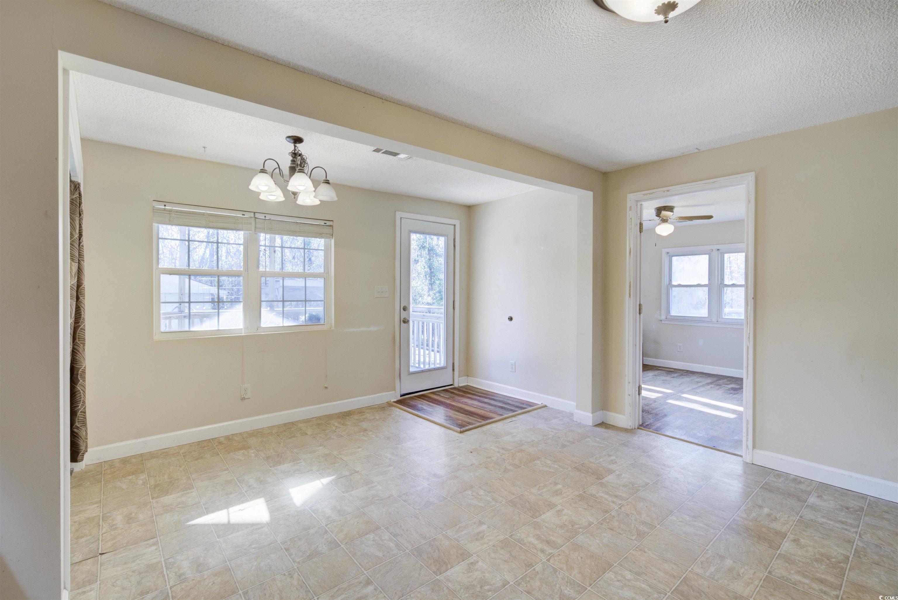 2080 Highway 90 Conway, SC 29526 - Photo 16 of 29 Foyer featuring a textured ceiling, a ceiling fan, and a chandelier