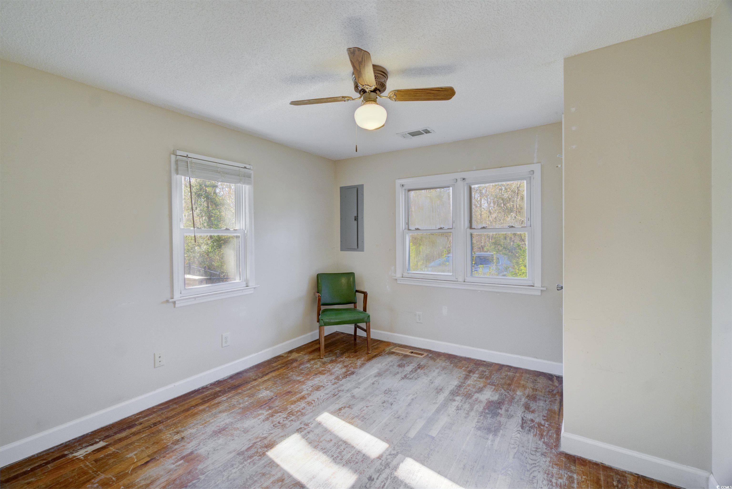 2080 Highway 90 Conway, SC 29526 - Photo 17 of 29 Unfurnished room with wood finished floors, a textured ceiling, a ceiling fan, and electric panel