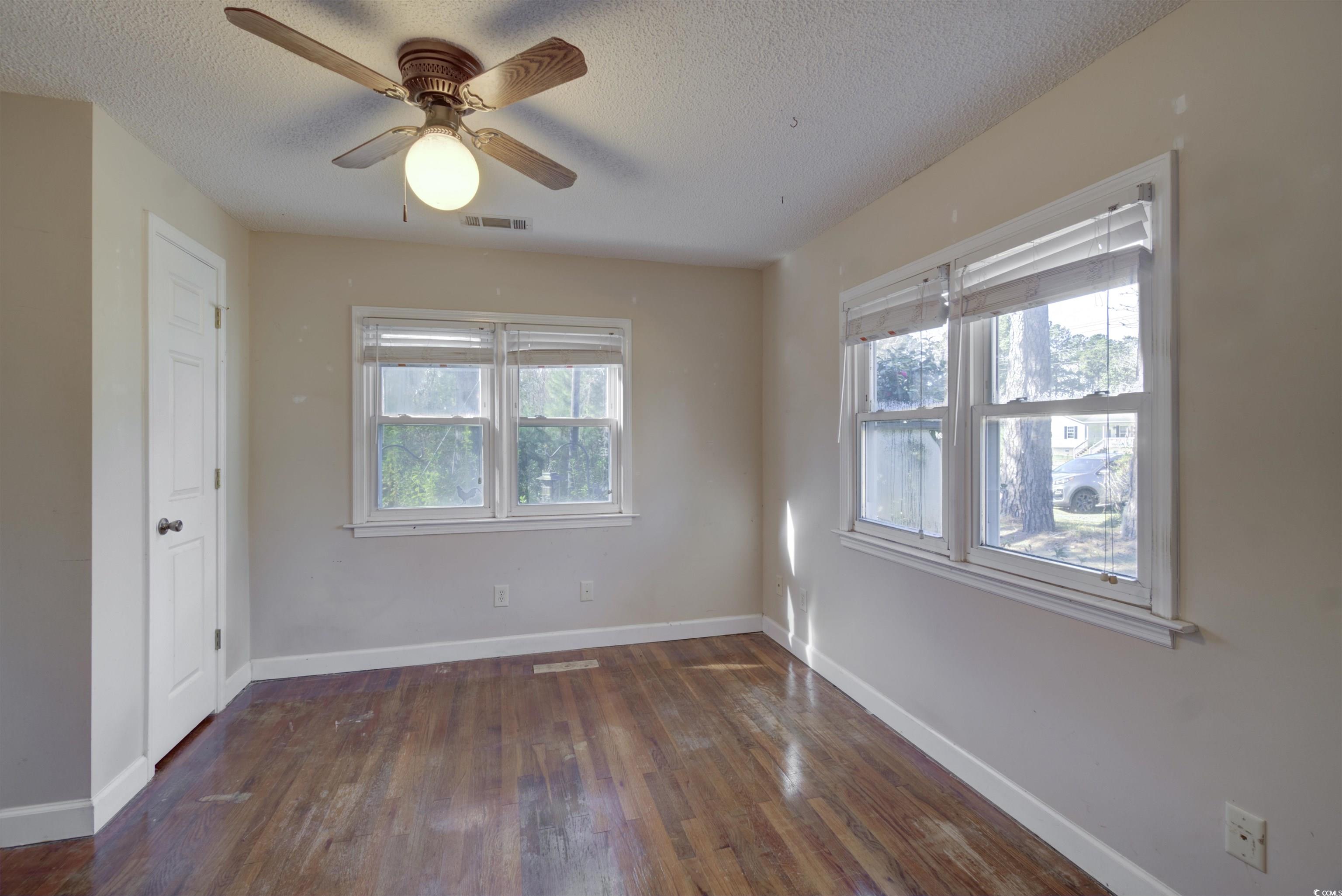 2080 Highway 90 Conway, SC 29526 - Photo 21 of 29 Spare room with dark wood-type flooring, a textured ceiling, and a ceiling fan