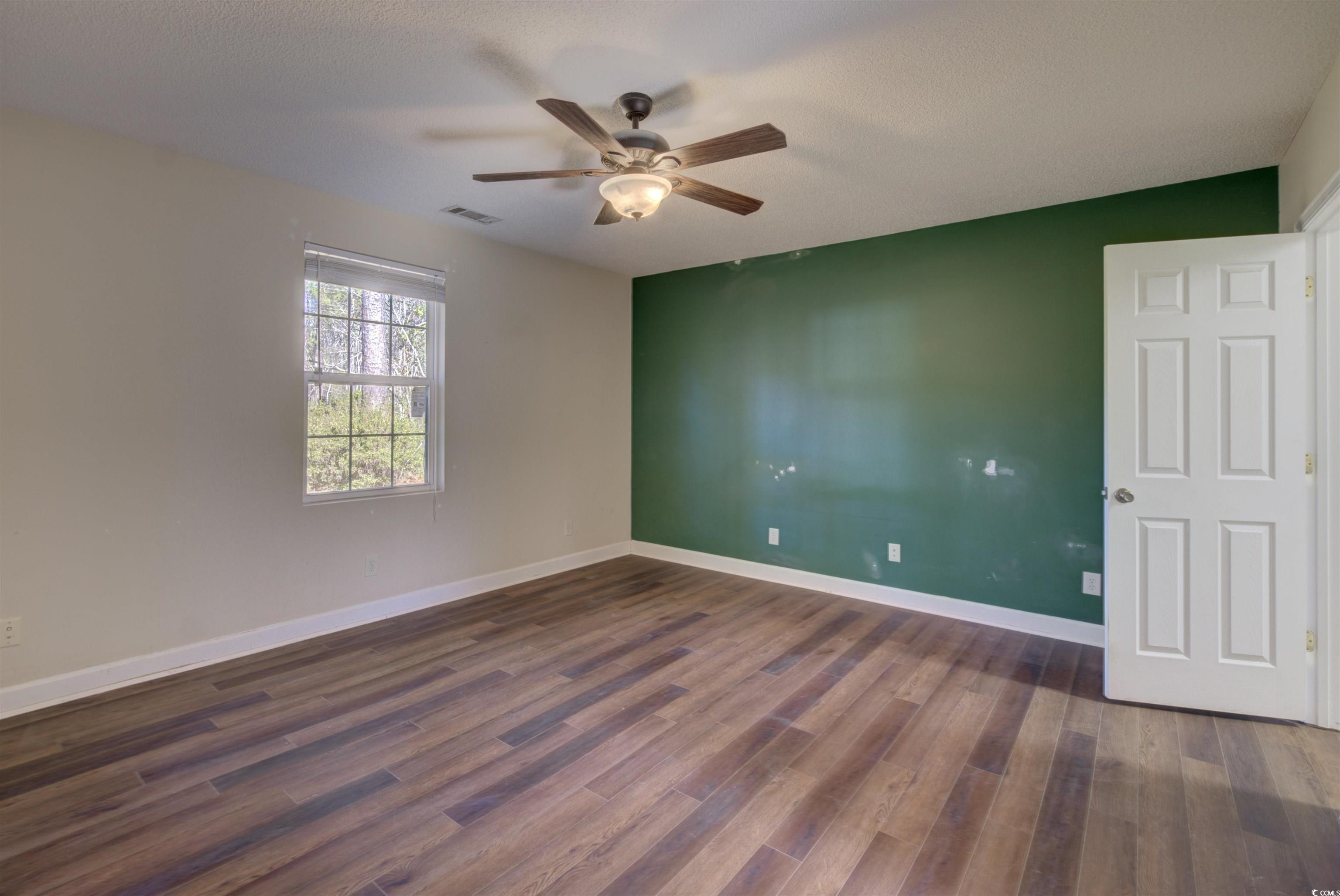 2080 Highway 90 Conway, SC 29526 - Photo 24 of 29 Unfurnished room featuring dark wood-style floors, a ceiling fan, and a textured ceiling