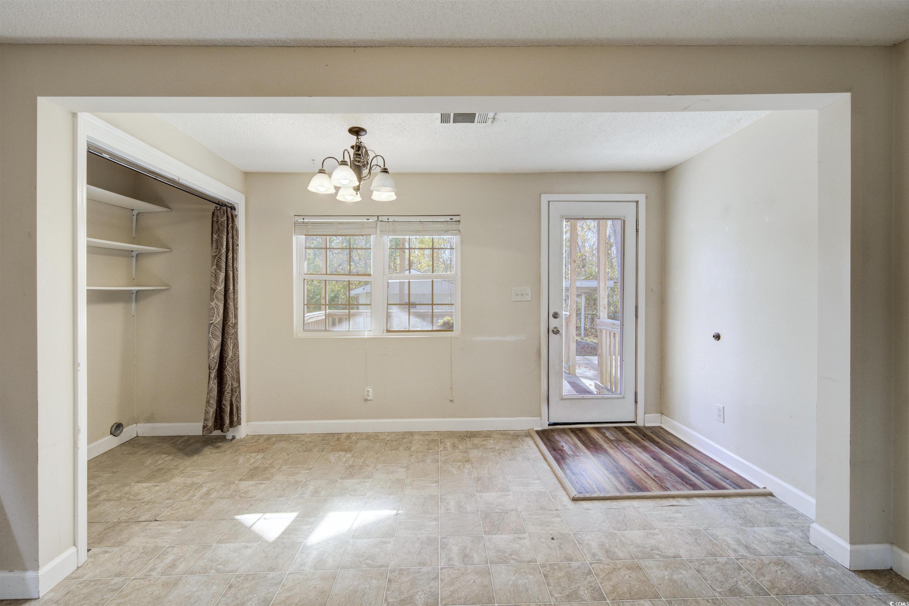 2080 Highway 90 Conway, SC 29526 - Photo 10 of 29 Doorway to outside featuring a chandelier and baseboards