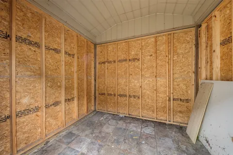 an aerial view of residential houses with outdoor space and parking