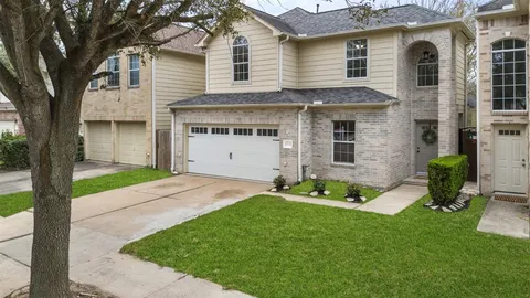 a front view of a house with a garden and yard