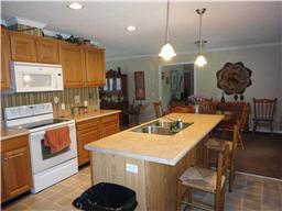 299 Knott Road Winchester, TN 37398 - Photo 7 of 20 The eat in kitchen has oak cabinets and a large pantry. Exit to the covered deck through the dining room.