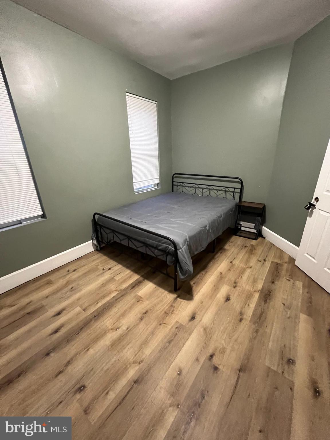 1402 Poplar Grove Street Baltimore, MD 21216 - Photo 12 of 15 a bedroom with a bed and window