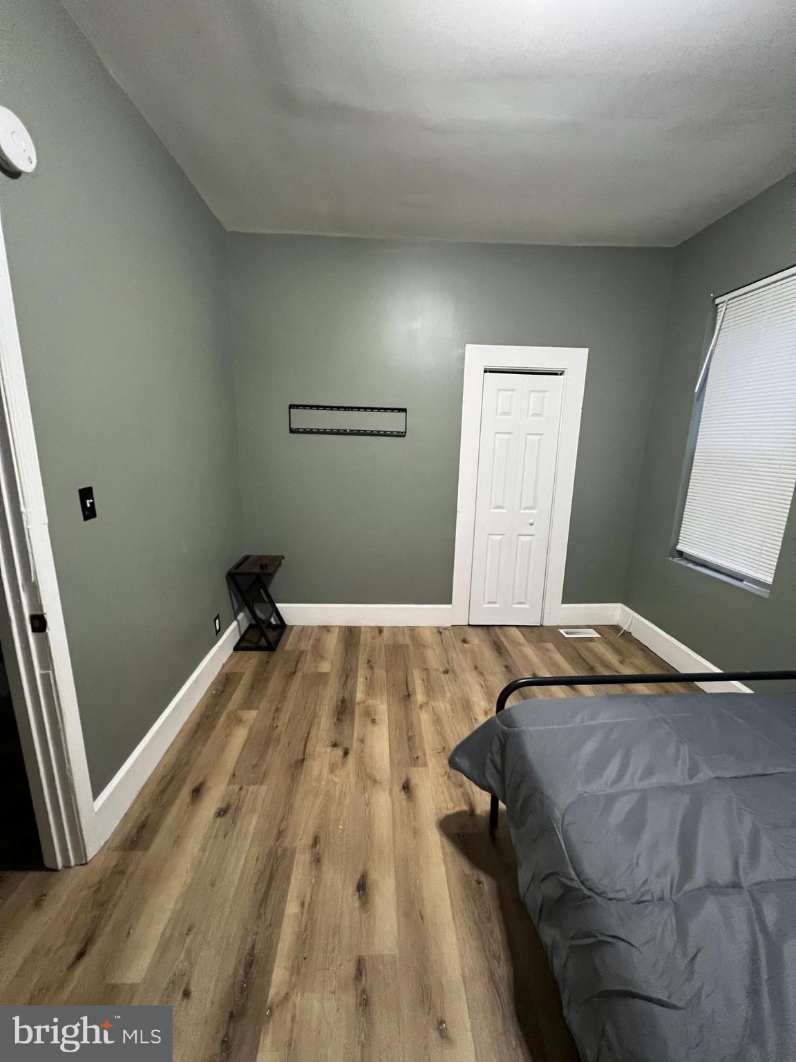 1402 Poplar Grove Street Baltimore, MD 21216 - Photo 15 of 15 a bedroom with a bed and a window