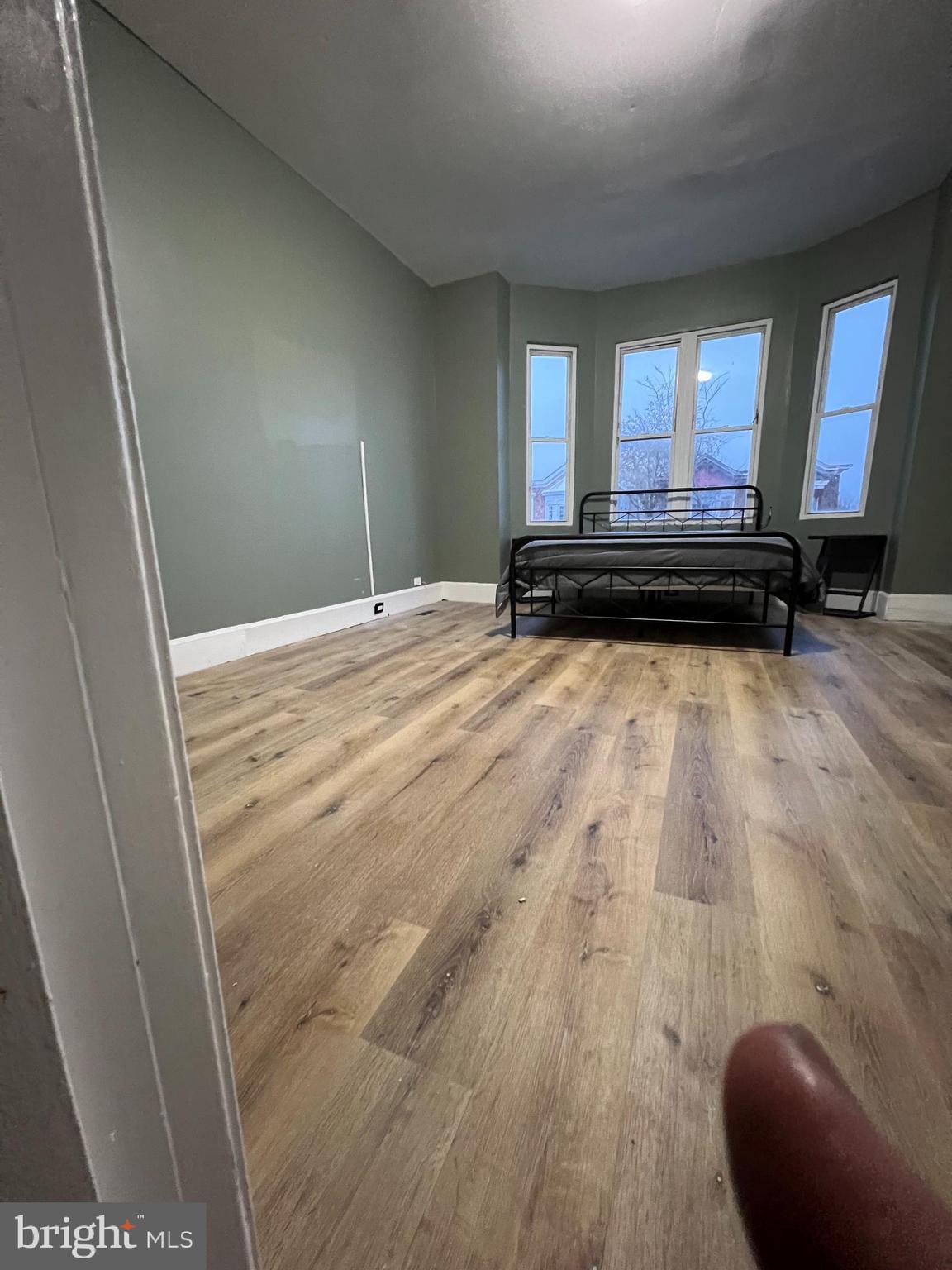 1402 Poplar Grove Street Baltimore, MD 21216 - Photo 2 of 15 a view of a room with wooden floor and furniture