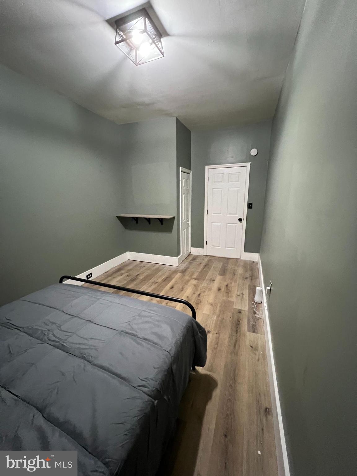 1402 Poplar Grove Street Baltimore, MD 21216 - Photo 6 of 15 a bedroom with a bed and window