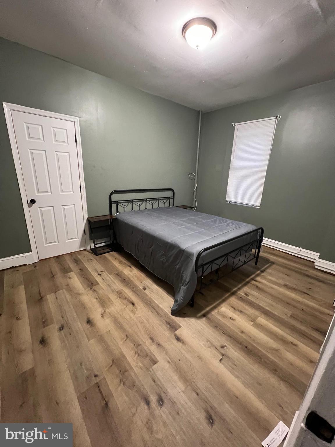 1402 Poplar Grove Street Baltimore, MD 21216 - Photo 8 of 15 a spacious bedroom with a bed and a window