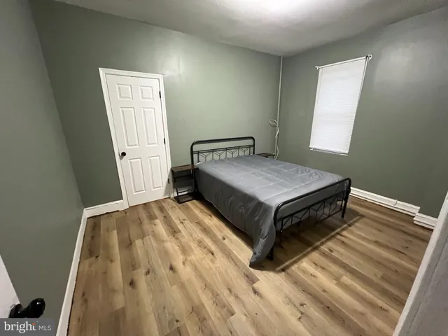 a bed sitting in a bedroom next to a window