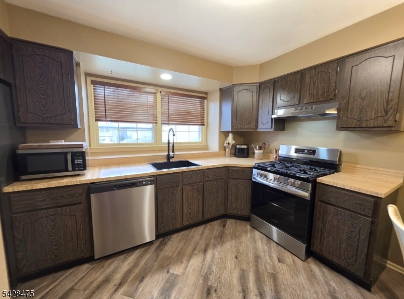 1030 Robin Road Hillsborough, NJ 08844 - Photo 12 of 22 a kitchen with a sink stove and cabinets