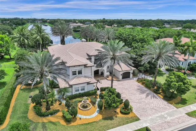 an aerial view of a house with a yard and potted plants