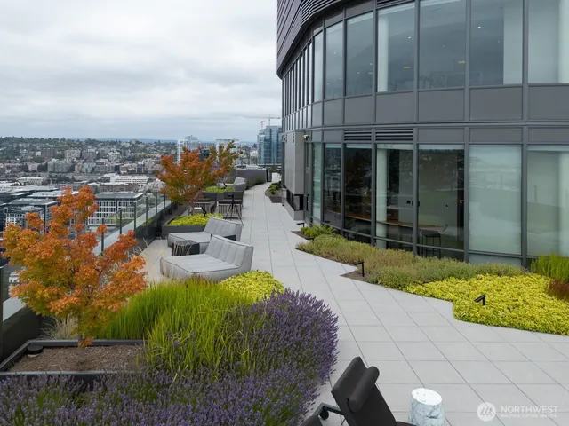 a swimming pool with outdoor seating and yard