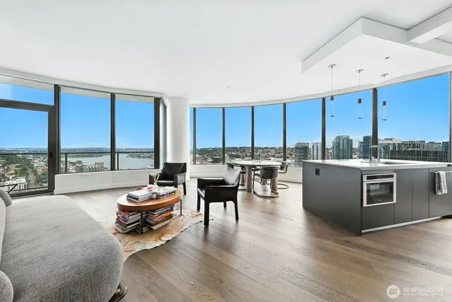 a dining room with large window and furniture