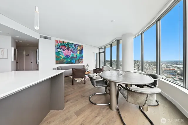 a living room with furniture and a floor to ceiling window