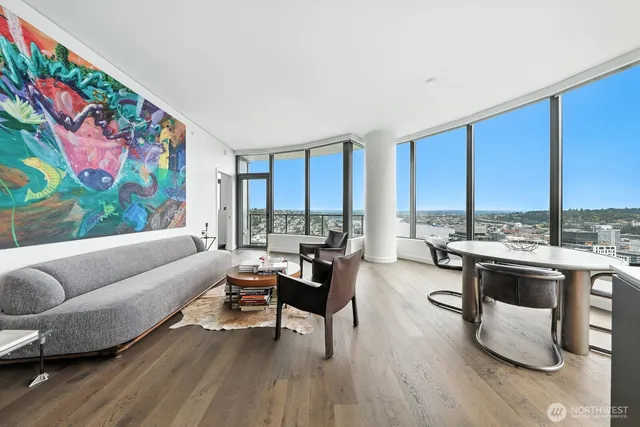 a bedroom with a bed and painting on the wall