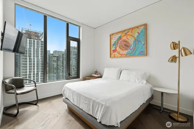 a bedroom with a large bed and a large window