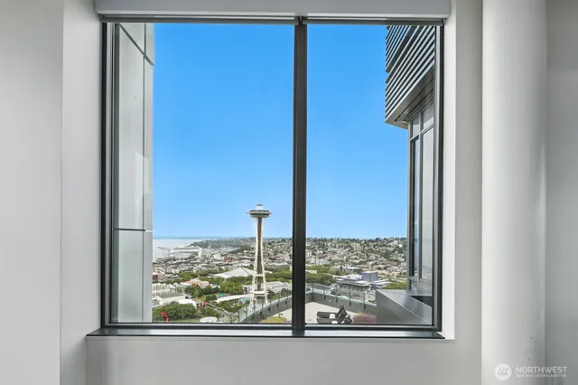 a view of a floor to ceiling window and a table in the living room