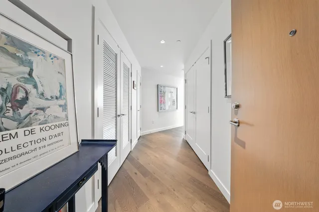 a living room with furniture a large window and kitchen view