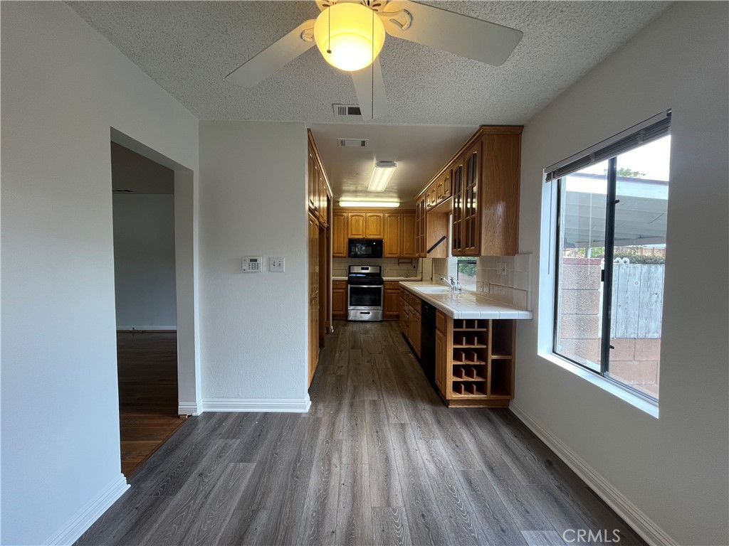 18029 Santa Rita Street Encino, CA 91316 - Photo 6 of 20 wooden floor in an empty room and a kitchen