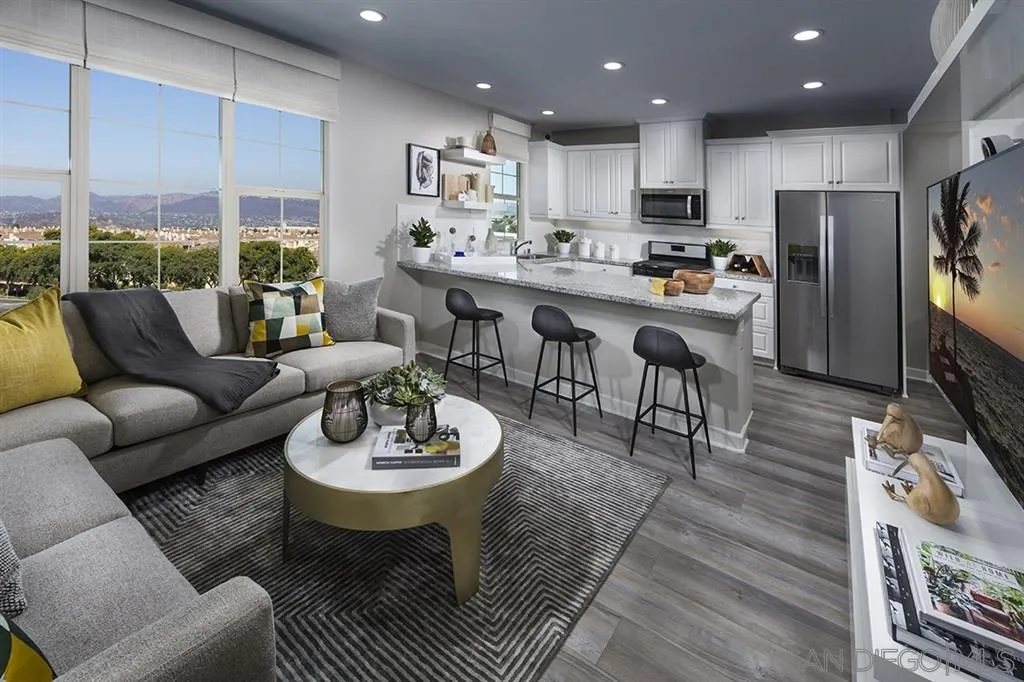 959 Slate San Marcos, CA 92078 - Photo 4 of 9 a living room with stainless steel appliances a dining table wooden floor and a view of kitchen