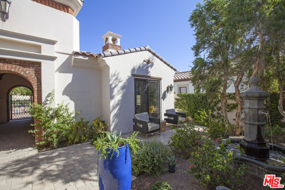 81805 Andalusia La Quinta, CA 92253 - Photo 24 of 45 a view of a house with potted plants and a bench