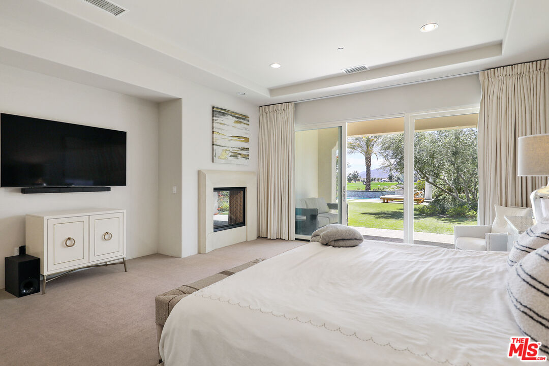 81805 Andalusia La Quinta, CA 92253 - Photo 27 of 45 a bedroom with a bed and a flat screen tv